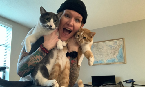 Melissa, happy human personal trainer, with her two cats